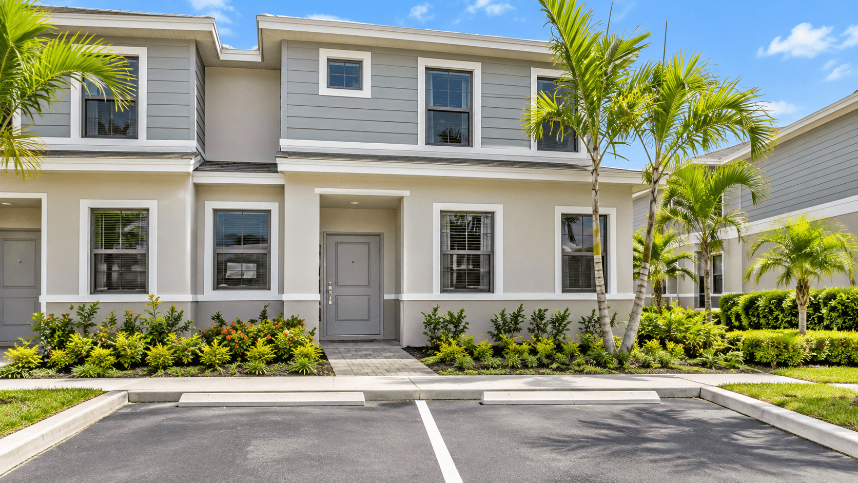 Two parking spaces in front of a Palm Cay townhome